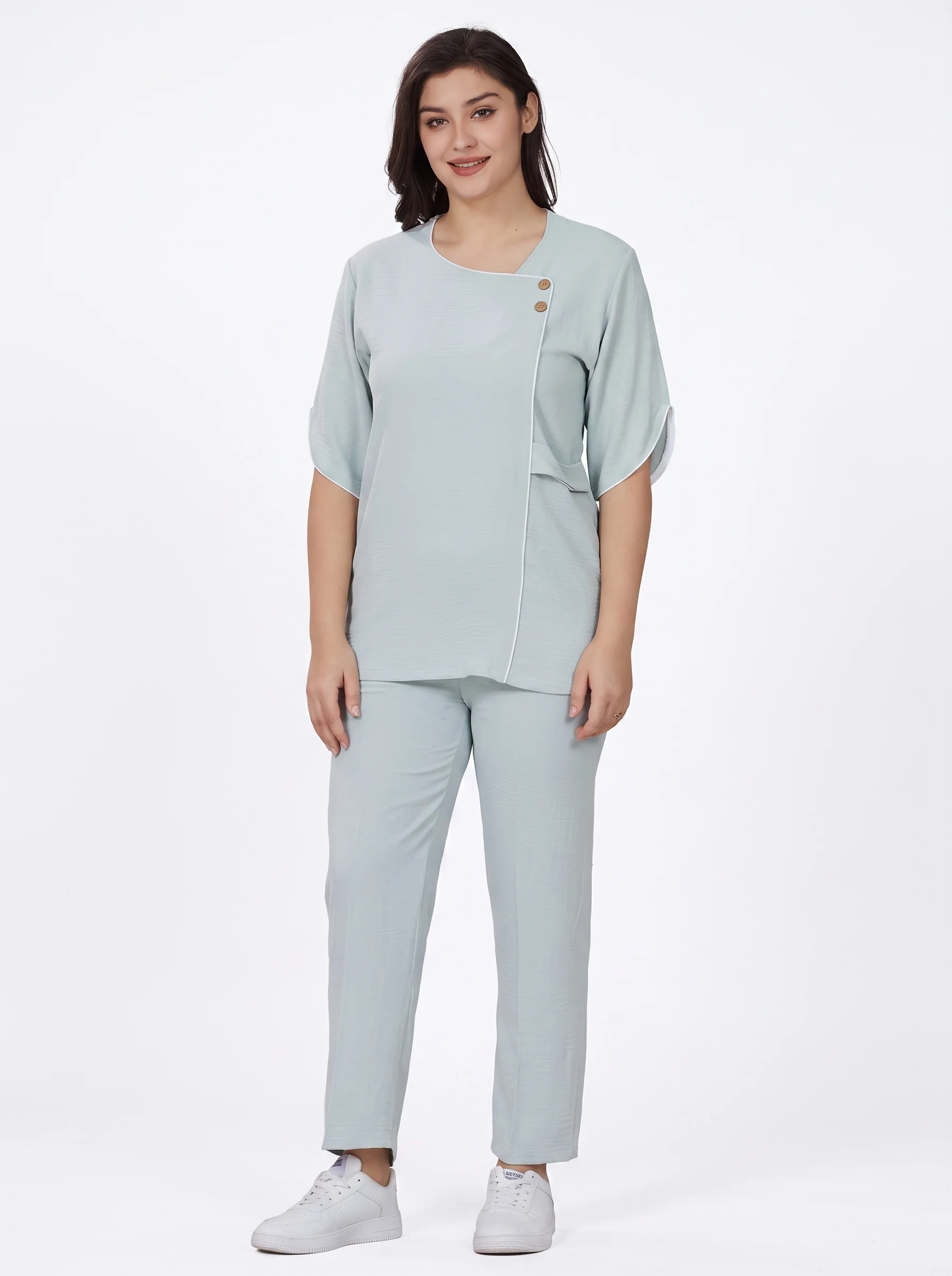 Woman_wearing_light_blue_uniform_202607091625 Asymmetric Button-Accent Wrap Uniform - Image 1